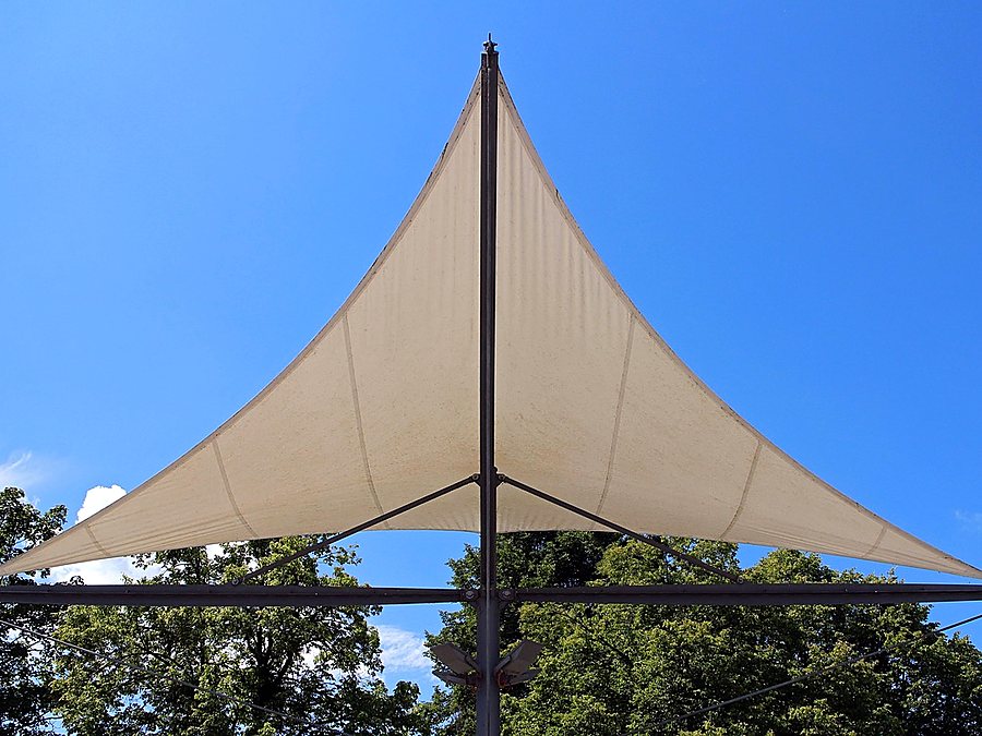 Toldo vela triangular tensado contra el cielo